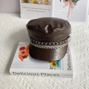 Detail of dark brown PU leather baker boy hat with triple layer metal chain decoration