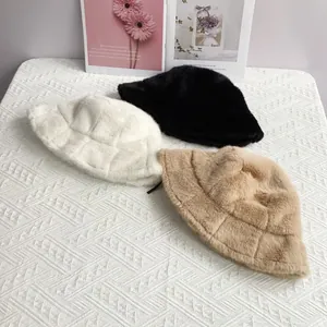 Detailed close-up of plush faux mink fur bucket hats featuring embossed checkered patterns
