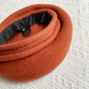 Detail of wool beret inner lining with sweatband and metallic rivet edge finish