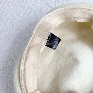 Détail de l'intérieur du béret en laine avec étiquette 90% laine et bande interne