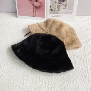 Detailed view of warm faux mink fur bucket hats in black and khaki on a lifestyle background