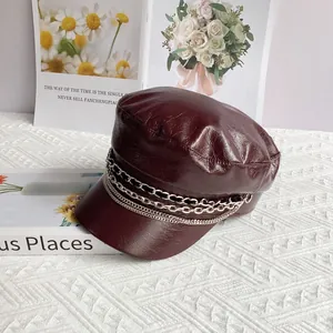 Detailed view of burgundy PU leather baker boy hat with triple silver metal chains