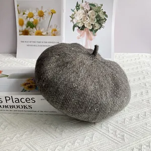 Close-up of charcoal grey chenille knit beret with subtle sequin details and texture