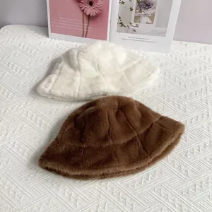 Detail of plaid embossed faux fur bucket hats in beige and brown on knit fabric