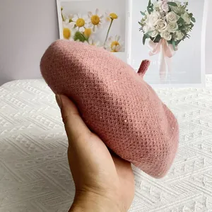 Detail of pink chenille knit beret featuring sparkling sequins and a textured finish