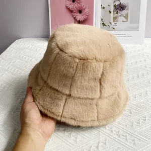 Detailed texture of beige faux mink bucket hat with unique square pattern and plush finish