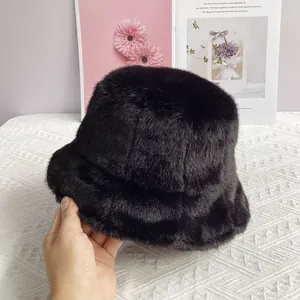 Detail view of black faux fur bucket hat showing soft texture and premium plush material