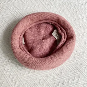 Close-up of pink chenille knitted beret with subtle silver sequins for winter fashion