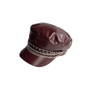 Faux leather burgundy newsboy hat featuring decorative layered metal chains in a side view