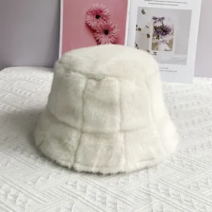 Detail of white plush bucket hat featuring a quilted checkerboard texture on soft fabric