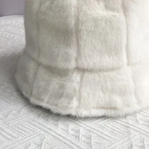 Detail of white faux mink fur bucket hat featuring a 3D checkered texture and soft plush finish