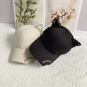 Punk style cat ear baseball cap with metal studs and embroidery in black and beige