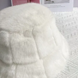 Close-up of white plush bucket hat showing faux fur texture and striped segment design