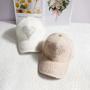 Detail of warm rabbit hair blend baseball caps featuring sparkling rhinestone heart patterns