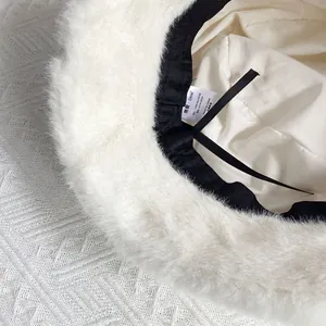Detail of white faux mink fur bucket hat with internal adjustable strap and lining