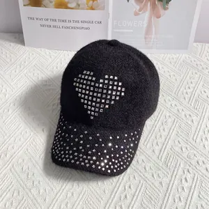 Detailed macro view of black knit baseball cap with sparkling rhinestone heart decoration