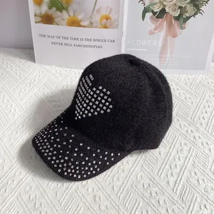 Macro detail of black rabbit fur blend cap featuring sparkling rhinestone heart patterns