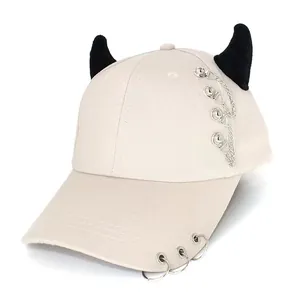 Detail of off-white devil horn baseball cap with punk metal chains and brim rings