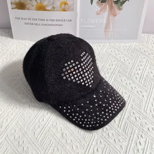 Close-up of black rabbit fur blend baseball cap featuring a silver rhinestone heart