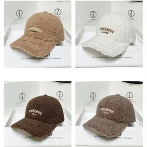 Detail showing plush sherpa baseball caps in four colors with embroidered letters