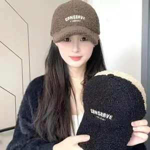 Detail of warm lamb wool baseball caps with high-quality white embroidery text textures