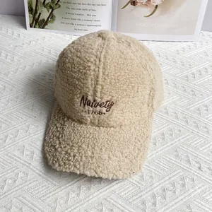 Close-up of beige fleece baseball cap featuring high-quality Naivety letter embroidery