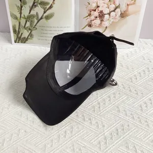 Detail view of black punk baseball cap with internal plastic support and adjustable strap