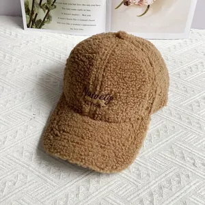 Close-up of brown sherpa baseball cap with Naivety 1768 embroidery on soft fleece fabric