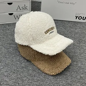 Close-up of teddy fleece baseball caps with detailed embroidery and warm fuzzy texture
