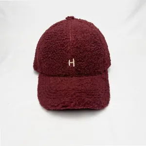 Winter burgundy faux shearling baseball cap with embroidered H letter and warm fleece texture