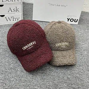 Fleece baseball caps in burgundy and khaki with embroidered lettering and warm texture