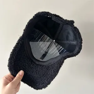 Detailed interior view of a black fuzzy lamb wool baseball cap with lining and support
