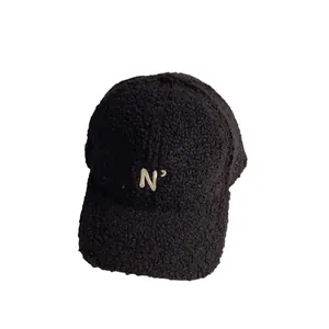 Black teddy fleece baseball cap with embroidered letter N in a minimalist winter style