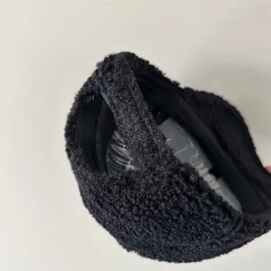 Detailed view of a black fuzzy lamb wool baseball cap showing its warm and soft texture