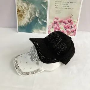 Detailed view of rhinestone STAR baseball caps with sparkling PARIS and NY lettering
