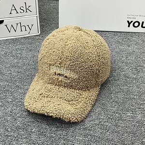 Close-up of khaki faux shearling baseball cap with embroidered CONSERVE letters