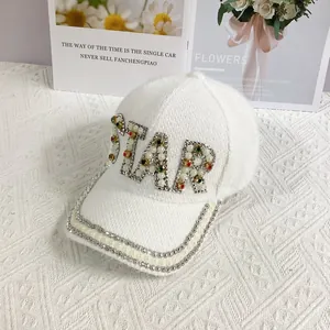 Detail showing STAR lettering in pearls and rhinestones on white faux mink baseball cap
