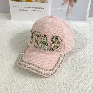 Close-up of pink baseball cap with STAR lettering made of rhinestones and pearls