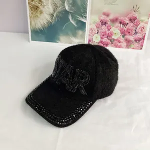 Detailed view of the STAR rhinestone embroidery on black faux mink fur baseball cap