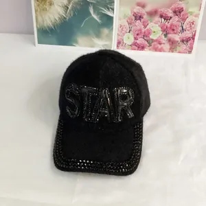 Detail of black faux mink baseball cap featuring STAR rhinestone lettering on front