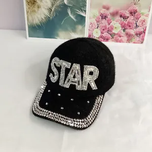 Close-up of STAR rhinestone lettering on premium black plush velvet baseball cap