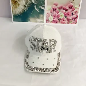 Close-up of a white tweed baseball cap with silver STAR rhinestones and crystal brim