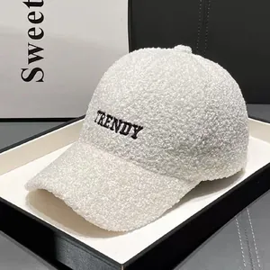 Detailed texture of white teddy fleece baseball cap with TRENDY embroidery logo
