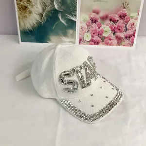 Close-up of luxury white baseball cap featuring hand-set STAR rhinestone lettering