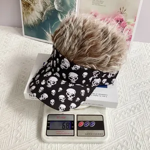 Skull print visor hat with synthetic hair wig shown on a scale weighing 68 grams