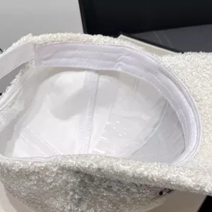 Detailed macro view of the soft white teddy fleece interior and inner lining of the cap