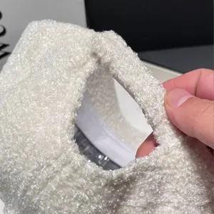Macro detail of plush teddy fleece handbag handle with white sherpa texture finish