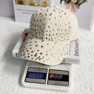 Close-up of lightweight off-white corduroy baseball cap with studs weighing 113 grams