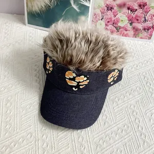 Close-up of funny wig baseball cap with heart patch and brown synthetic hair extensions