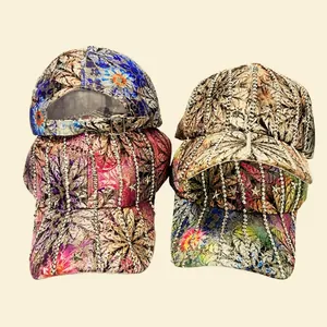 Detail of floral printed baseball caps with rhinestone stripes and star studs